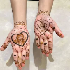 The cutest Teej mehendi, celebrating a mother-daughter bond with a sweet portrait and their initials.