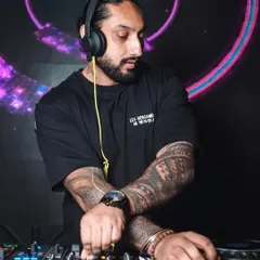 In the zone, crafting the perfect set. Every track is chosen to build momentum and create a unique musical journey, whether it's commercial hits, deep house, or Bollywood bangers.