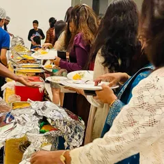 Guests lining up at our buffet during a birthday party at Purva Palm Beach. Our setup allows for a smooth flow of people, ensuring everyone can easily access the wide variety of dishes on offer.