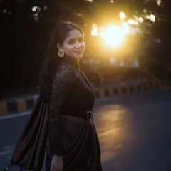 A beautiful solo portrait of the bride-to-be on a city street at sunset. The golden hour light creates a beautiful flare and highlights her elegant silhouette.
