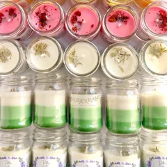 A closer look at the different styles in the wedding order, including pink candles with rose petals and green layered candles.