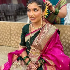 A stunning Peshwai wedding look. The makeup is kept natural and glowing to complement the rich saree and traditional gold jewelry, creating a timeless bridal portrait.