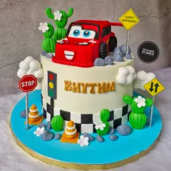 Kachow! This Lightning McQueen cake is ready to race. I sculpted the car from fondant and included fun, edible details like cacti, traffic signs, and a checkered flag finish line to bring the world of 'Cars' to life.