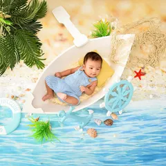 A tiny sailor adrift on a calm sea. This creative newborn setup uses a boat prop and a beachy backdrop to create a sweet and imaginative scene.