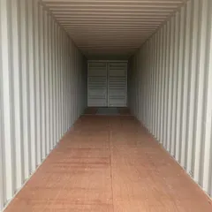 This perspective shows the durable flooring and strong, corrugated steel walls of a standard shipping container. This robust construction ensures your assets are protected from the elements.