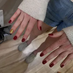 This is one of the RCB players getting her nails done. We chose a classic red with a single gold glitter accent nail to match their team colors.