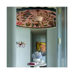 Why limit wallpaper to walls? Applying a beautiful pattern to the ceiling is a unique way to spruce up your interiors and up the glam quotient. This hallway is transformed by its stunning, artful ceiling.