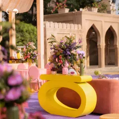 A view of the eclectic seating arrangement at our Moroccan-themed party. The mix of modern yellow consoles, blush-toned seating, and lush floral centerpieces created a vibrant and opulent atmosphere.