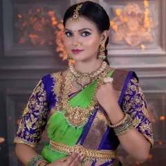 This is a full bridal set with layered temple necklaces, including a choker and a long haram with a goddess motif, paired with a matching vaddanam (waist belt).