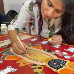 Every detail matters. Here, I'm adding the finishing touches to a custom Pichwai painting. This is where I get lost in the process, ensuring every line and colour tells the client's story with care and precision.