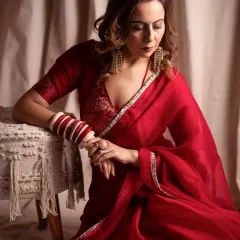 A quiet moment of reflection. For this editorial shoot, we focused on soft lighting and a gentle mood to complement the elegance of the red saree, creating a frame that feels both timeless and deeply personal.