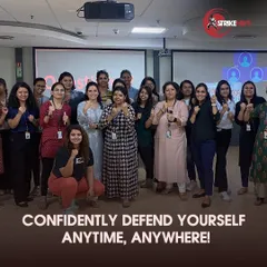 A group of empowered employees poses together after a successful corporate wellness session. Our workshops are not just about learning moves; they are about building team morale, fostering a sense of security, and creating a more confident workforce.