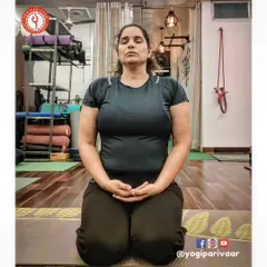 "Through meditation, we can train our minds." A student sits in Vajrasana (Thunderbolt Pose), a stable and comfortable posture for practicing dhyana and pranayama, allowing the mind to settle and focus inward.