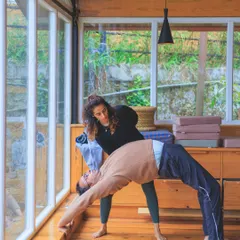 Assisting a student in Urdhva Dhanurasana (Wheel Pose). With the right support, we can often go further than we think is possible, finding new strength and openness.