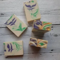 A comparison of two different pour styles for my lavender soap. The bars on the left have a delicate leaf-like pattern, while the ones on the right feature a more abstract, free-form swirl.
