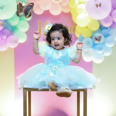 A playful pose from the birthday girl. Our colorful pastel backdrops and props create a fun and cheerful atmosphere for photos.