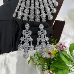A close-up of the intricate, chandelier-style earrings that come with the cascading AD necklace.