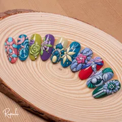 I love working with textures. Here, I've used my emboss gel technique to create raised floral and bow designs, each with its own unique pattern and color story, displayed on a natural wood slice.
