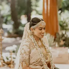 The serene glow of a Telugu-Malayali bride during her Muhurtham. I focused on creating a radiant, skin-focused look with subtly defined eyes, perfectly complementing her classic white and gold saree.
