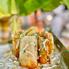 The Jini Dosa is a Mumbai street food favorite that I love to bring to my events. This crispy dosa is filled with a medley of vegetables and sauces, then rolled, cut, and served for a flavor-packed bite every time.