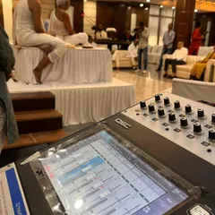 Here you can see my professional sound mixing setup in action during a spiritual discourse. I use top-tier equipment like this QSC digital mixer to guarantee crystal-clear audio for revered spiritual leaders and guest speakers.
