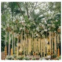 An ethereal wedding mandap designed for a modern fairytale. Draped in white florals and lush greenery, with strings of tuberoses cascading from above, this setup creates a serene and romantic ambiance for the main ceremony.
