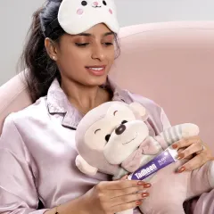 A lifestyle shot for the Tadheen sleep balm campaign. The model is in pajamas with a cute sleep mask, creating a cozy and relatable scene that communicates the product's purpose.