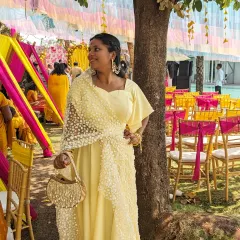 A beautiful and lightweight outfit for a daytime Haldi function. The yellow gown is paired with a delicate pearl-work dupatta for an elegant and comfortable look.