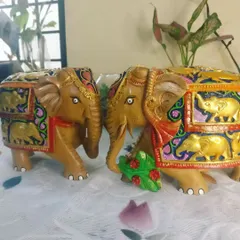 A pair of wooden elephants that I hand painted with intricate traditional designs and vibrant colors. These are perfect as a unique home decor accent.