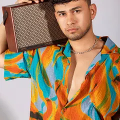 A vibrant, tropical-themed shoot for a men's summer collection. I paired a colorful printed shirt with white shorts and casual accessories like headphones and a speaker to create a fun, youthful, and energetic vibe.