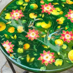 This finished lotus pond side table is a vibrant piece of art. The rich green background makes the pink and yellow lotuses pop, creating a stunning visual centerpiece.