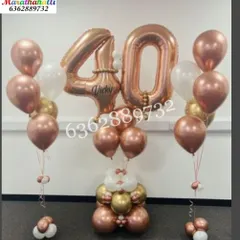 A chic and elegant bouquet for a 40th birthday. This standing arrangement features large rose gold '40' number foils, personalized with the name 'Vicky', and flanked by matching helium balloon bunches.