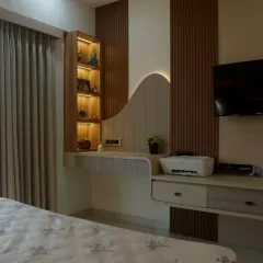This view shows the integrated study and display unit in the same bedroom, designed with the same wavy motif to maintain a cohesive and artistic feel.