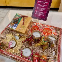 Another traditional Diwali shagun hamper. This one includes decorative diyas, incense, and small jars of kumkum and haldi, all beautifully arranged in a festive tray.
