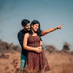 A happy, candid moment during an outdoor photoshoot, where the couple shares a laugh while looking towards their future. We encourage natural interactions to bring out your true personalities.