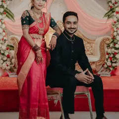 The couple sharing a moment at their wedding. The bride's custom blouse was designed to perfectly match her traditional saree.