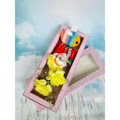 Another version of our cute hamper, this one featuring a colorful crocheted bee alongside yellow carnations and Skittles.