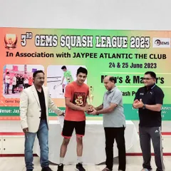 Diwakar Singh, the winner of the Men's category, receiving his trophy at the 3rd Gems Squash League.