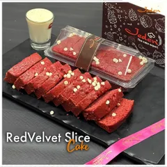 Our Red Velvet Slice Cake offers our signature flavor in a convenient loaf. This vibrant red, moist cake is studded with white chocolate chips, providing a perfect grab-and-go indulgence.