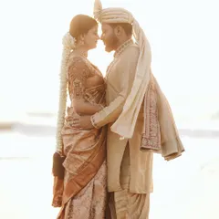 A romantic silhouette of a couple against the setting sun on a beach. This kind of shot is perfect for capturing the dreamy, magical feeling of a destination wedding.