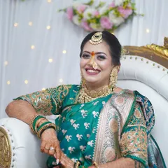 A beautiful engagement look in a traditional green saree. The makeup features a pop of color on the eyes and a warm lip, creating a fresh and celebratory feel.