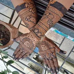 A full view of a floral engagement design, personalized with the couple's initials and engagement rings. The dark stain makes the delicate floral patterns and personal touches stand out.