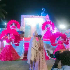 Our dancers framing the couple during their Varmala ceremony. The vibrant props and costumes add a touch of royal grandeur to this Jain wedding in Mysore.