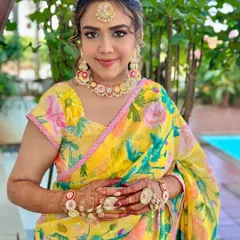 A soft Haldi look radiating with vibrant yellow hues. The floral jewelry and fresh makeup create a perfect blend of tradition and grace for this pre-wedding ceremony.