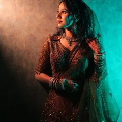Another shot from the same series, this pose captures a sense of mystery and elegance through the use of creative lighting.