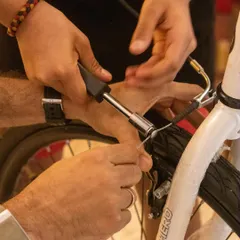 Learning practical life skills is a core part of our philosophy. Here, students work together to understand the mechanics of a bicycle, learning how to adjust brakes and handle tools, which empowers them to fix things themselves.