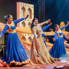 A performance from our Sufi night concept. The bride's dance was enhanced by professional dancers with flowing orange drapes, set against a backdrop of Mughal-style arches on the LED screen.