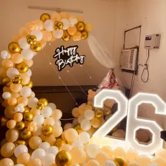 Another view of the elegant 26th birthday decor, showing how the warm lighting from the marquee numbers and neon sign creates a celebratory glow.