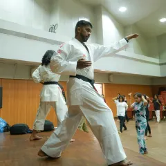 I demonstrate a foundational karate stance during a self-defense workshop. Mastering these core movements is key to building effective self-protection skills.