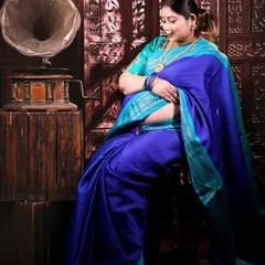 Another pose from this traditional session, with the mom-to-be seated, looking down lovingly at her bump. The composition is classic and full of grace.